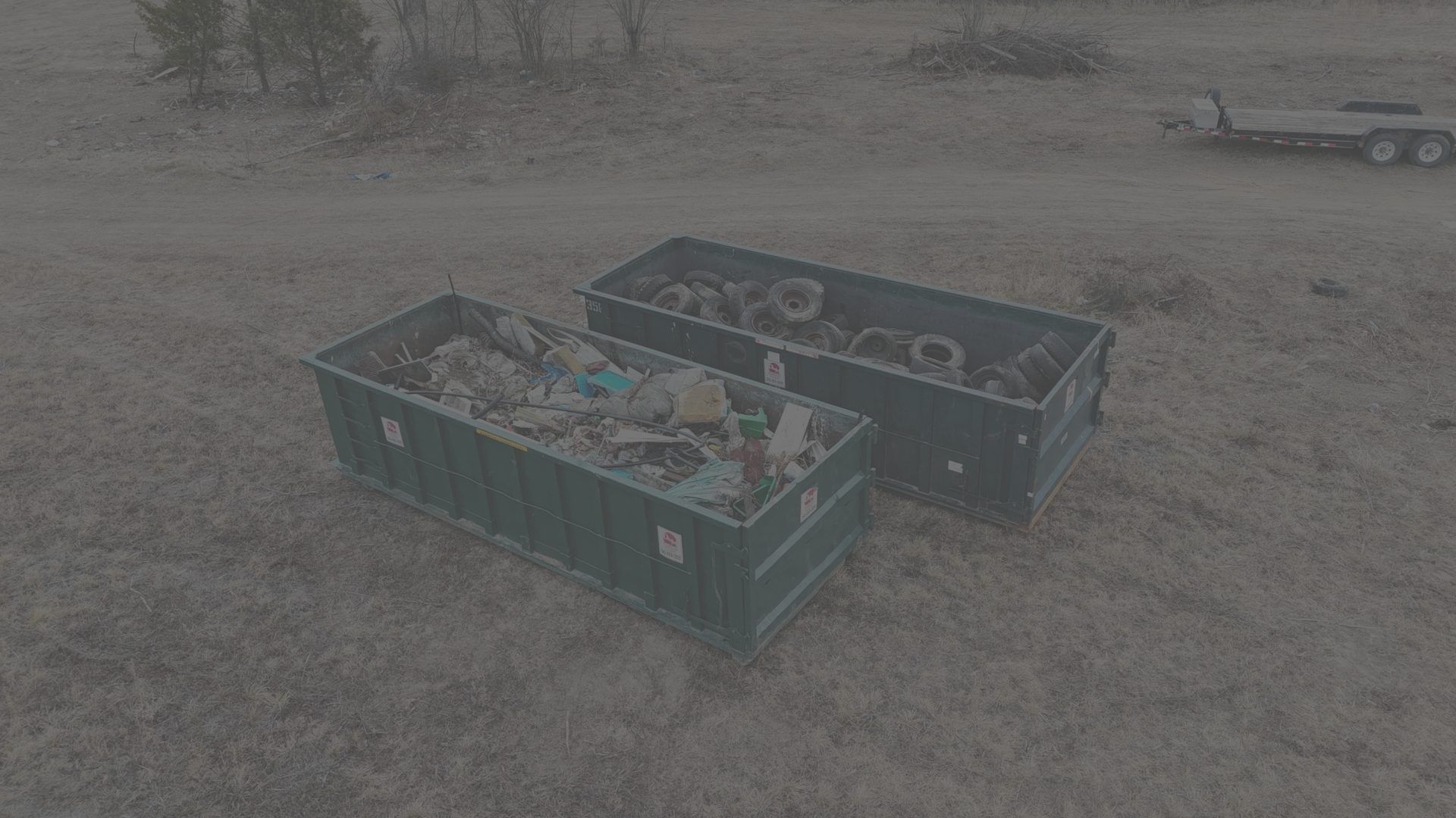 Dumpster Rental Services in Middletown VA, green D&M roll off dumpsters loaded with debris, drone view