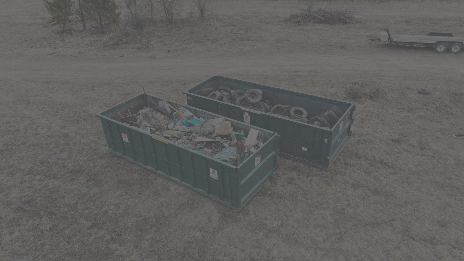 Dumpster Rental Services in Hamilton VA, green D&M roll off dumpsters loaded with debris, drone view